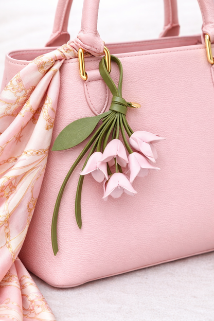 Pink  Petite Lily Bag Charm  with leather strap on purse with scarf. 