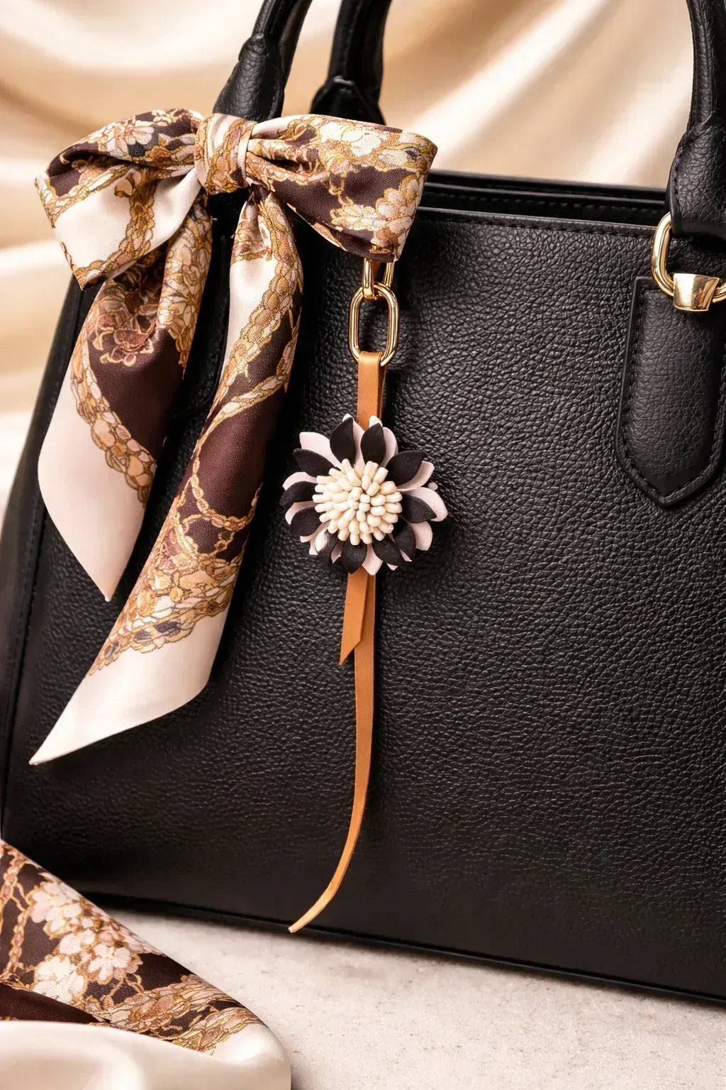 White Autumn Rosette Charm on black purse with scarf. 