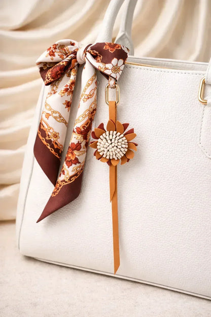 White Autumn Rosette Charm on white  purse with scarf. 