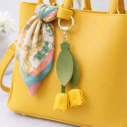 Yellow Sweetheart Tulip Bag Charm with key ring on purse with scarf. 