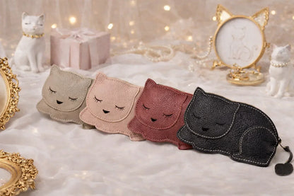  4 leather cat-shaped card holders with zipper pouch, sitting on table, perfect gift for cat lovers.