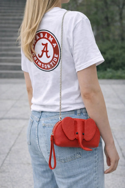 Small genuine leather elephant purse worn as a crossbody mini bag to show size and fit.