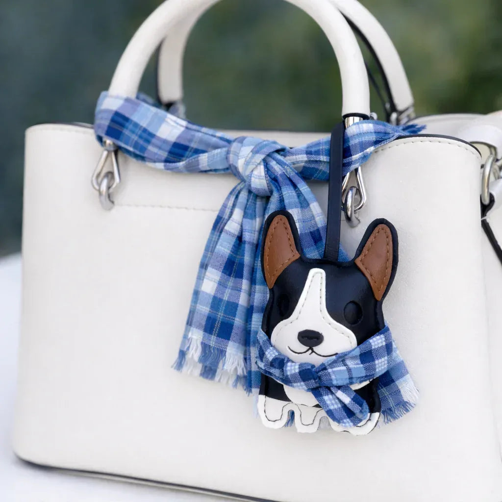 Dark Blue Corgi Companions Leather Bag Charm with leather strap on white purse and scarf. 