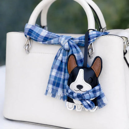 Dark Blue Corgi Companions Leather Bag Charm with leather strap on white purse and scarf. 