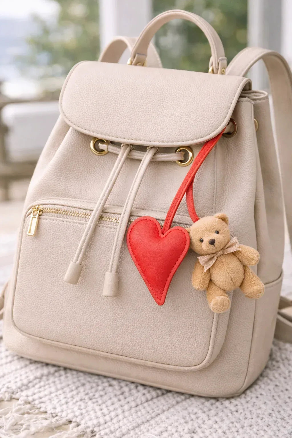 Red Carry Your Heart Collection Leather Heart Bag Charm on backpack. 