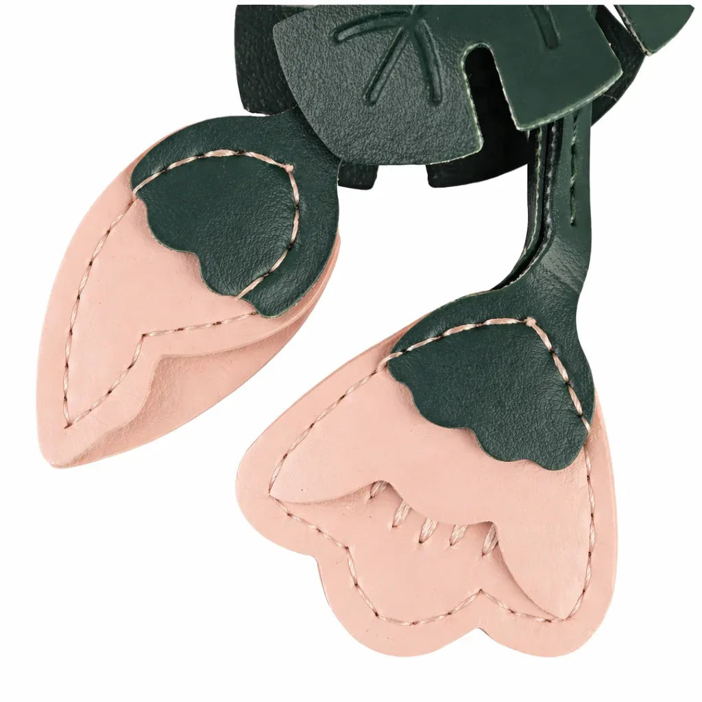 Close up of the Pink Monstera Bloom Leather Bag Charm. 