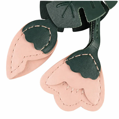 Close up of the Pink Monstera Bloom Leather Bag Charm. 