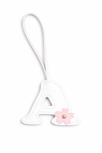 Initials in Bloom Alphabet Bag Charm "A" with leather strap on white background. 