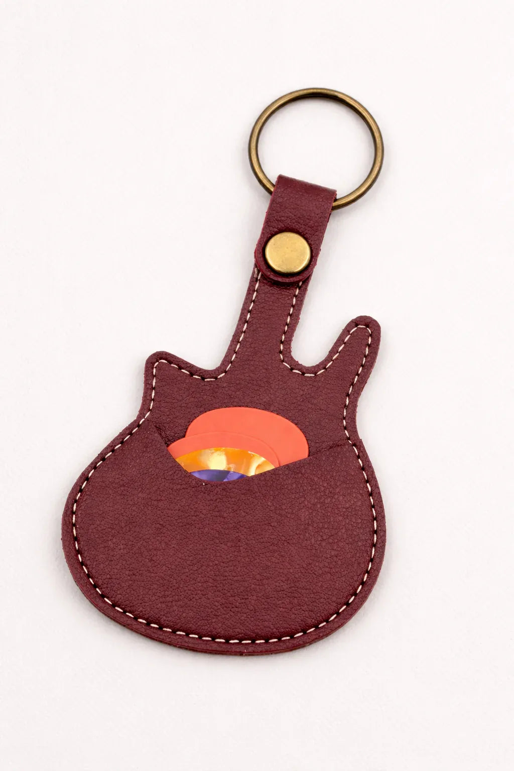 Handmade brown guitar-shaped leather keychain with a secure pick pocket and brass-tone ring.