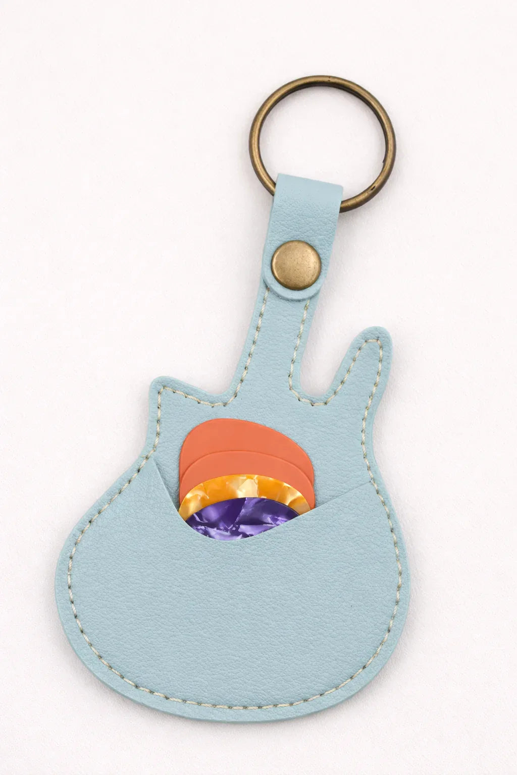 Handmade light blue  guitar-shaped leather keychain with a secure pick pocket and brass-tone ring.