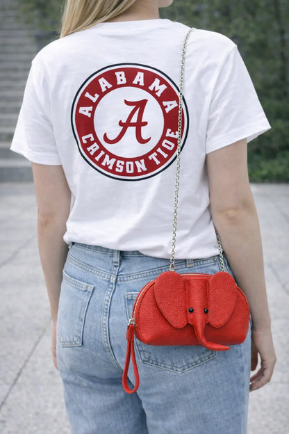 Small genuine leather elephant purse worn as a crossbody mini bag to show size and fit.