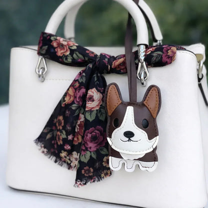 Brown Corgi Companions Leather Bag Charm with leather strap on white purse and scarf. 