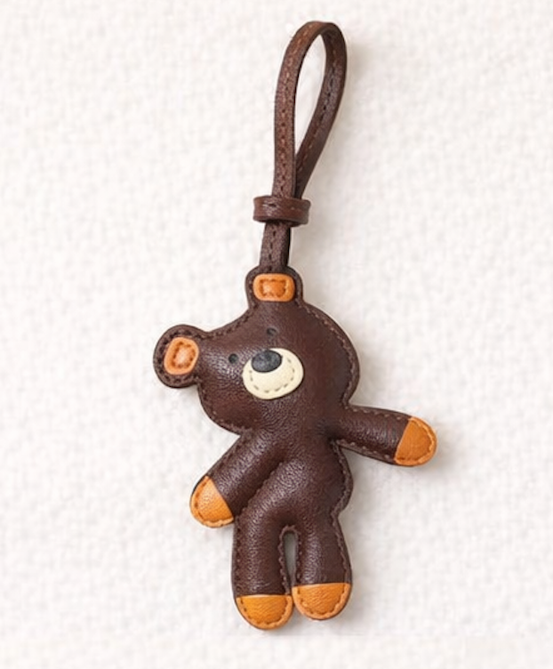 Brown teddy bear leather bag charm on a white background