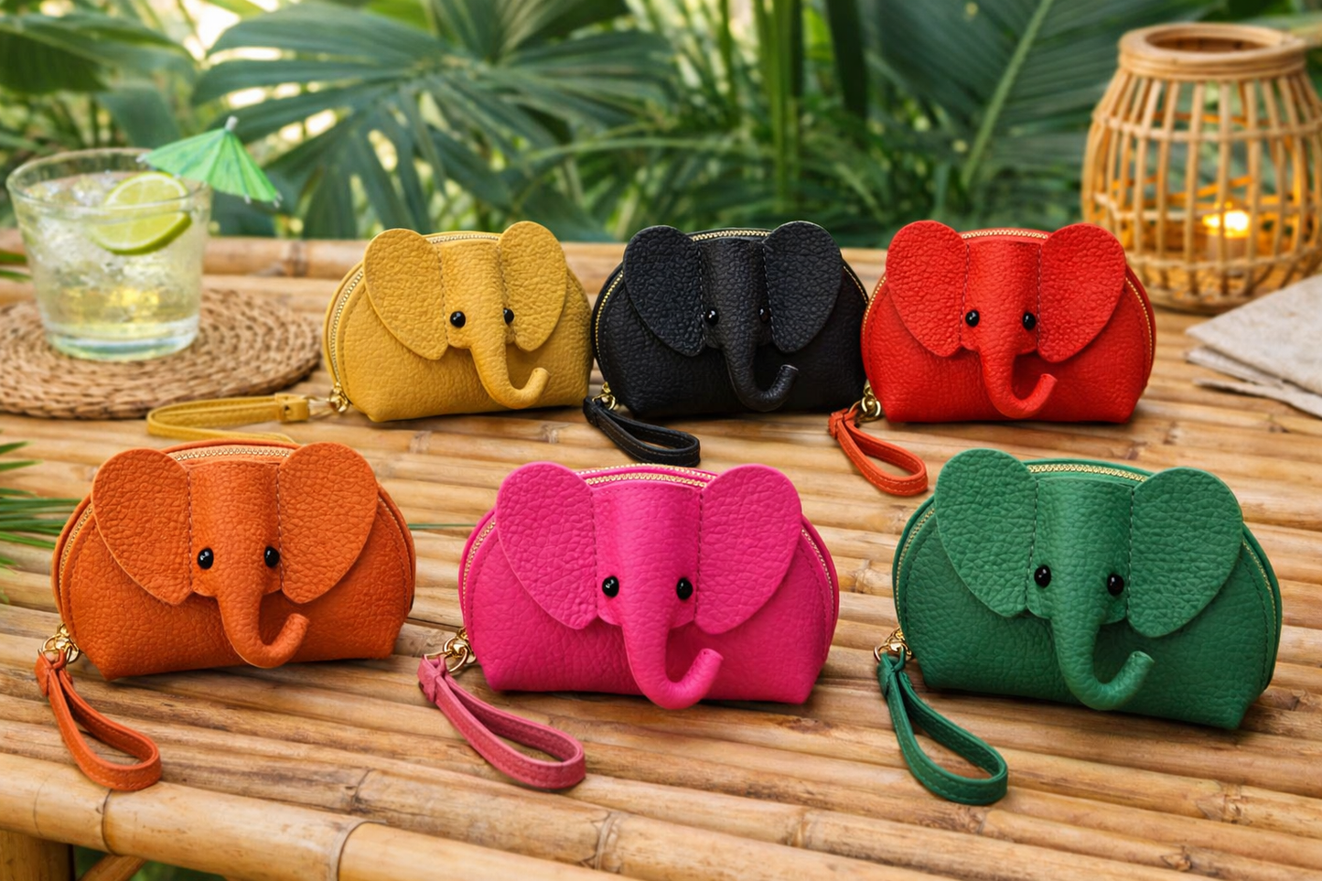 6 Baby Elephants on Parade genuine leather elephant-shaped coin pouch in multiple colors sitting on table.