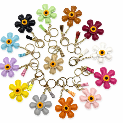 Assorted colorful leather flower keychains in daisy shapes from the Petal Parade collection.