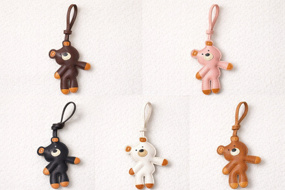 Five bear-shaped leather bag charms in different colors on a white background