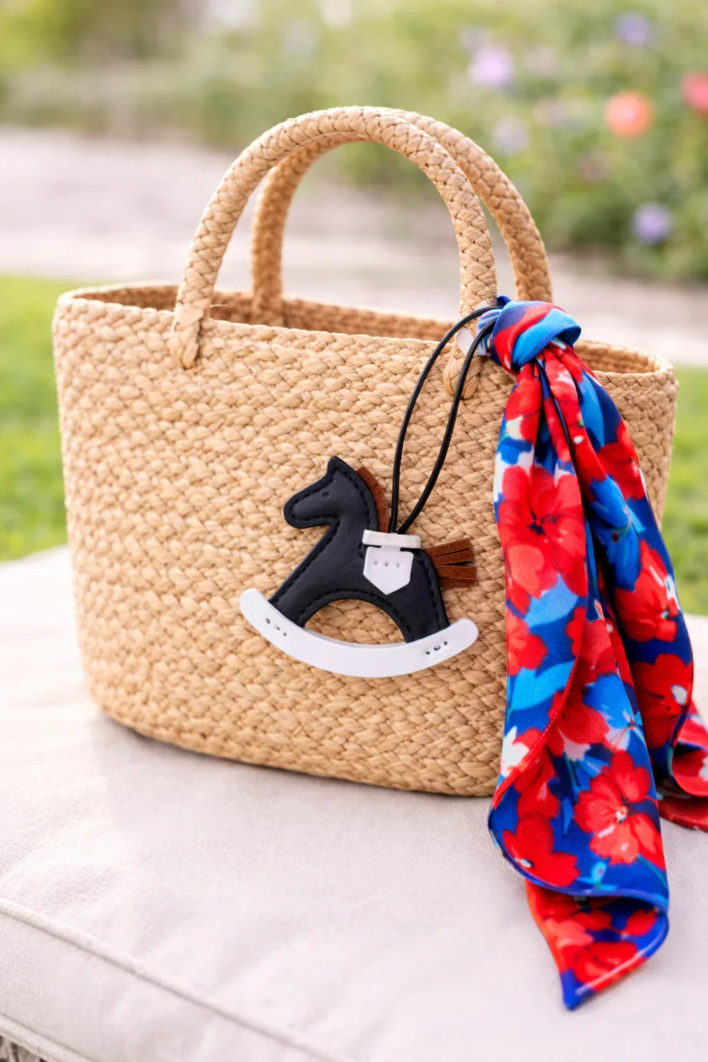 Black Rockabye Keepsake Horse Charm with leather strap on straw bag and scarf. 
