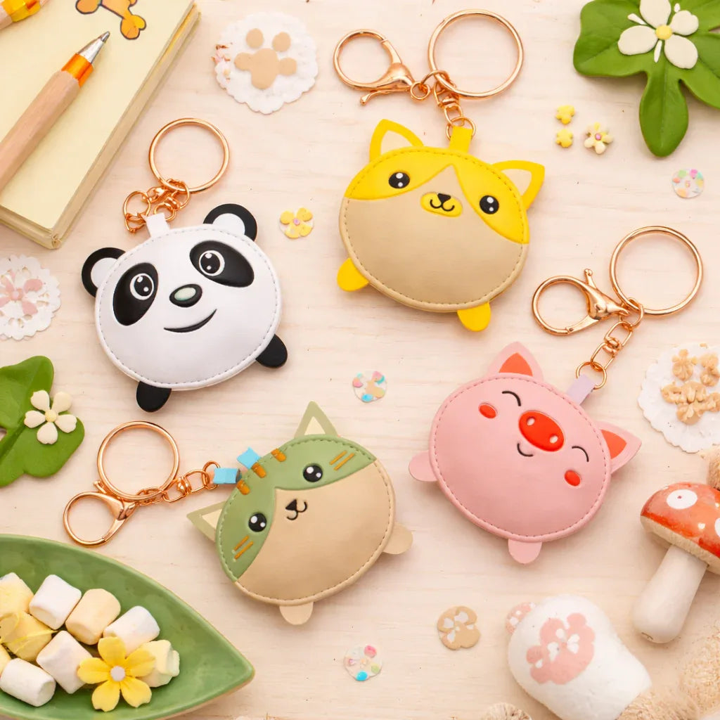 4 cute puddle pals with key ring and clasp on table. Panda, Pig, Cat, Dog