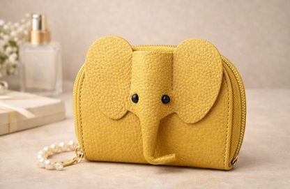 Elephant-shaped leather card holder in yellow with a secure gold zipper and multiple card slots.