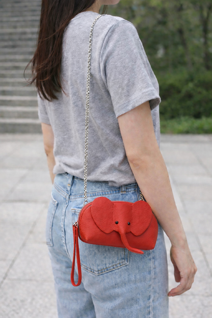 Small genuine leather elephant purse worn as a crossbody mini bag to show size and fit.