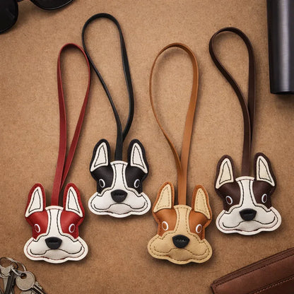4 different Bulldog Leather Bag Charms with leather strap in a row on a table. 