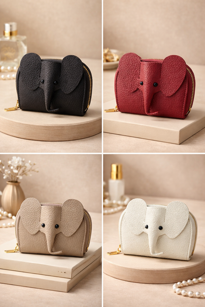 4 elephant-shaped leather card holders in  with a secure gold zipper and multiple card slots sitting on a table to show size.