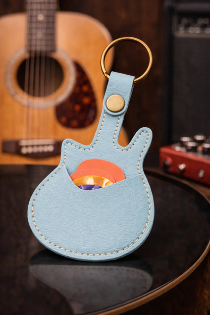 Handmade light blue guitar-shaped leather keychain with a secure pick pocket and brass-tone ring.