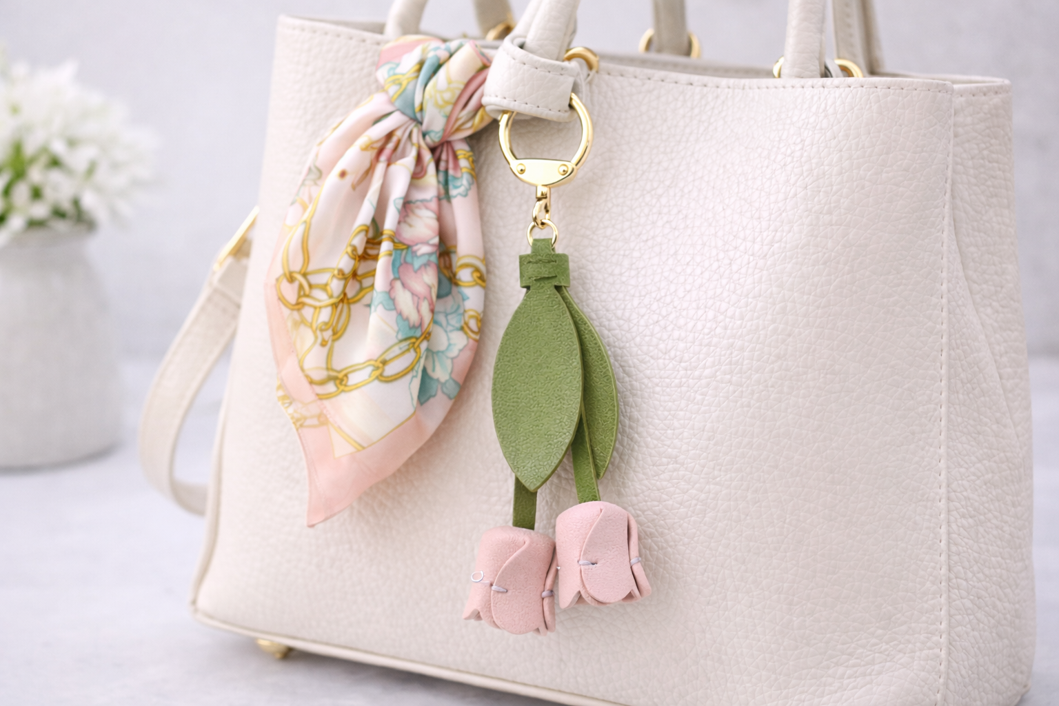 White Sweetheart Tulip Bag Charm with key ring on purse with scarf. 