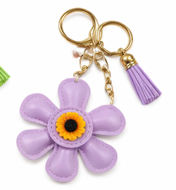Handmade purple leather daisy keychain with yellow center and gold clasp.