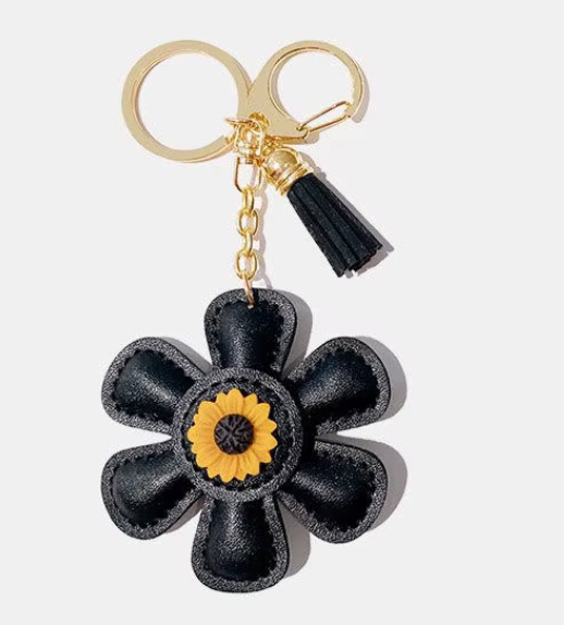 Handmade black  leather daisy keychain with yellow center and gold clasp.