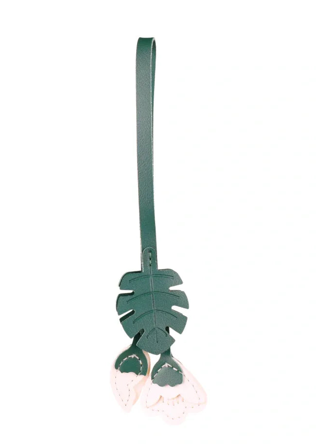 Cream colored Monstera Bloom Leather Bag Charm with leather strap 