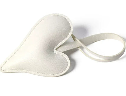 White Carry Your Heart Collection Leather Heart Bag Charm on white background. 