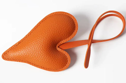 Orange  Carry Your Heart Collection Leather Heart Bag Charm on white background. 