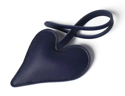Dark Blue Carry Your Heart Collection Leather Heart Bag Charm on white background. 