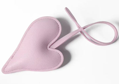 Grey Carry Your Heart Collection Leather Heart Bag Charm on white background. 