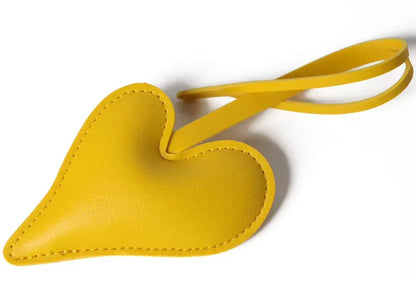 Yellow  Carry Your Heart Collection Leather Heart Bag Charm on white background. 