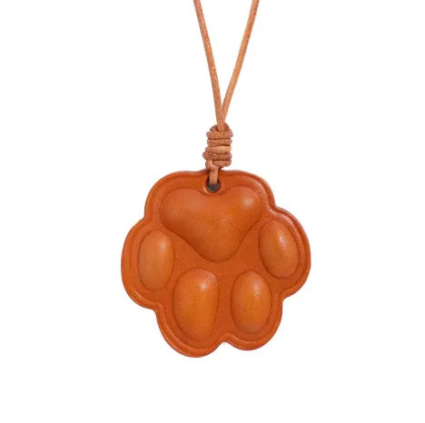Everyday Companion Orange Dog Paw Bag Charm  with leather strap. 
