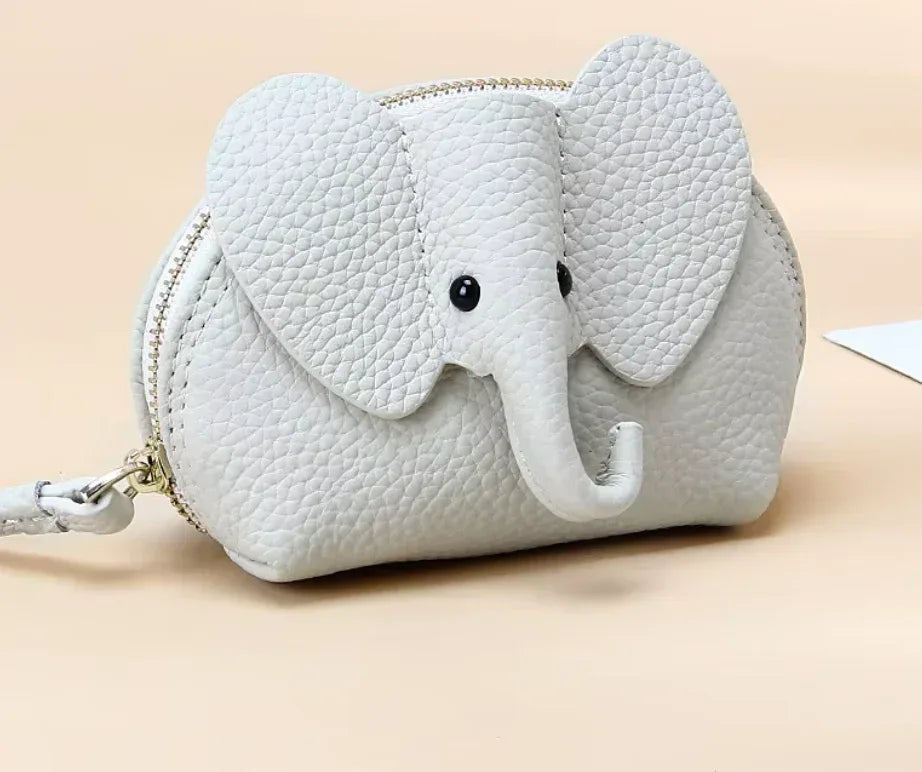 Baby Elephants on Parade genuine leather elephant-shaped coin pouch in White.