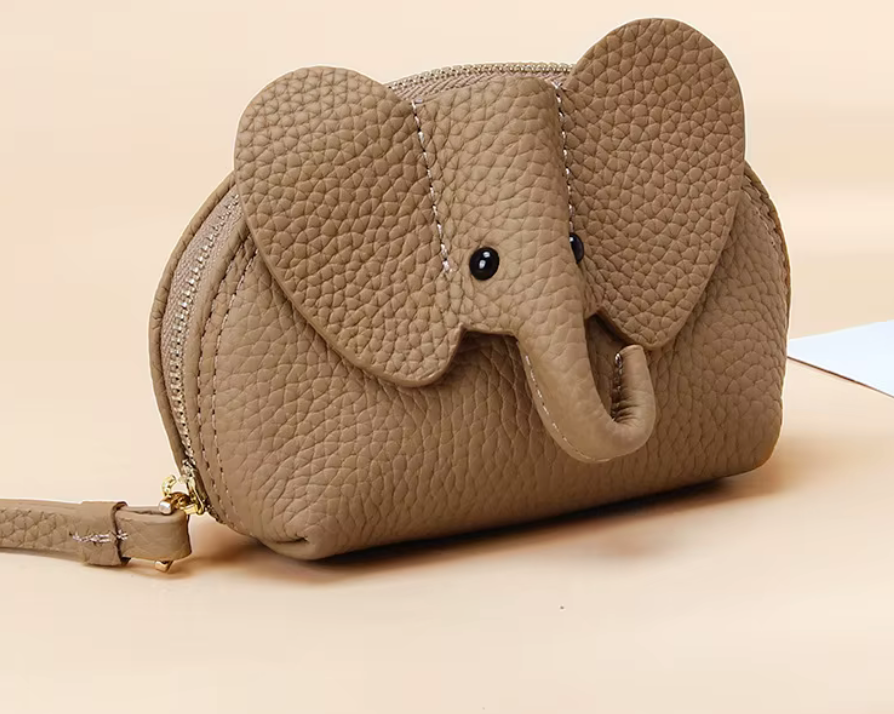 Baby Elephants on Parade genuine leather elephant-shaped coin pouch in Beige.