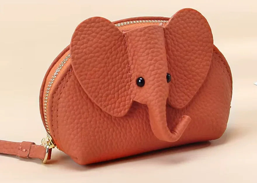 Baby Elephants on Parade genuine leather elephant-shaped coin pouch in Orange.