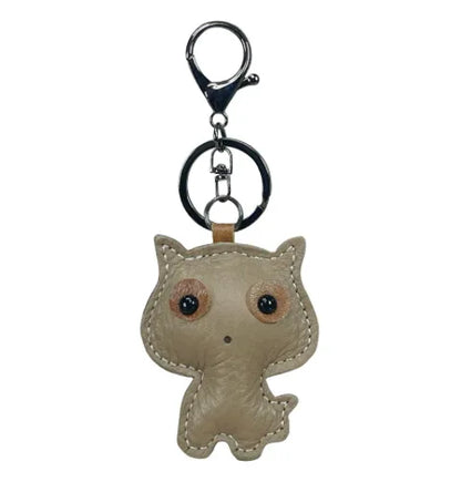 Brown handmade leather cat keychain with a minimalist silhouette and silver metal key ring.
