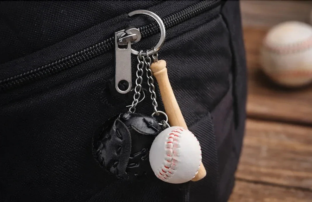 Baseball, Black glove and bat keychain on a pant zipper. 