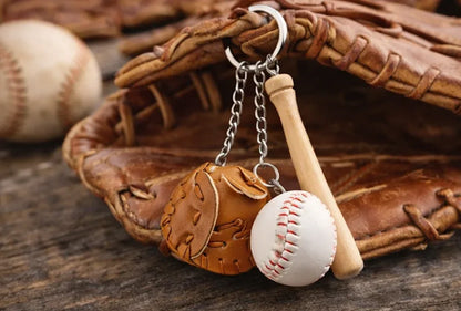 Baseball, glove and bat keychain on a baseball glove to show size. 