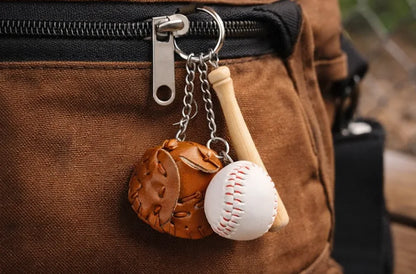 Baseball, glove and bat keychain on a pant zipper. 