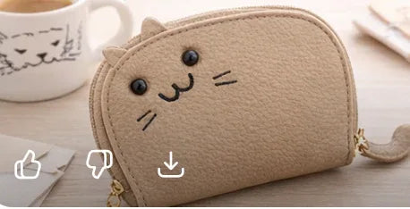 Handcrafted tan cat-shaped leather cardholder with a cute whiskered face and secure gold zipper and tail. 