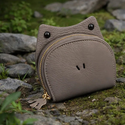 Handcrafted green leather frog-shaped card holder with a smiling face and gold zipper.