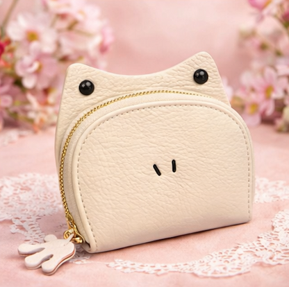 Handcrafted white leather frog-shaped card holder with a smiling face and gold zipper.