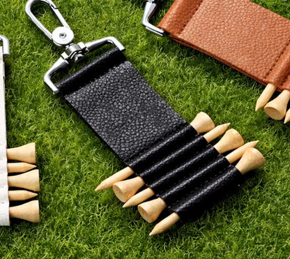 Black Leather Golf Tee Holder Keychain on grass and with golf accessories showing Tees in the holder. 