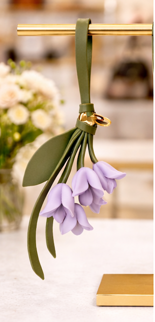Lavender Petite Lily Bag Charm  with leather strap on brass display.