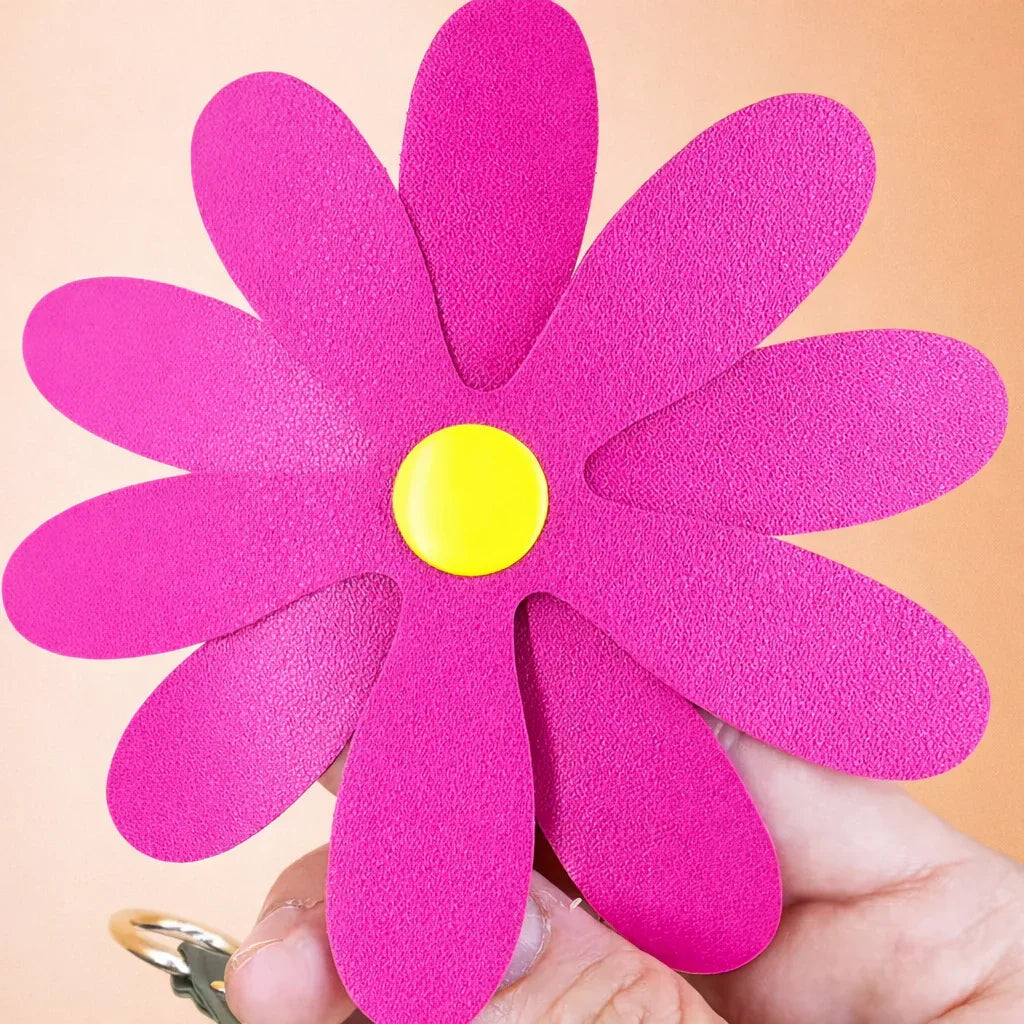 Close up of a pink Petal Pop Bag charm to show size and detail. 